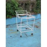 A THREE PIECE GARDEN SUITE comprising of a pair of white painted wrought iron low tables of