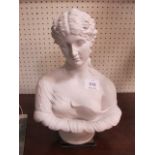 A WHITE MARBLE BUST OF A CLASSICAL FEMALE shown half length on a circular sockle 35cm