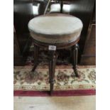 A REGENCY MAHOGANY STOOL the circular upholstered seat raised on lobed and ring turned legs and