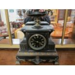 A BLACK MARBLE MANTLE PIECE CLOCK the breakfront top headed by a classical two handled urn above