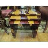 A NEST OF THREE WALNUT VENEERED TABLES of rectangular form with plain top and sides 51cm x 65cm x