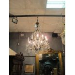 A CONTINENTAL STYLE GILT BRASS AND CUT GLASS TWELVE ARM CHANDELIER hung in two registers foliate