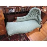 A VICTORIAN MAHOGANY CARVED CHAISE LONGUE the shaped buttoned upholstered back with serpentine