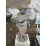 A COMPOSITION STONE FIGURE modelled as a young boy depicting winter 89cm high