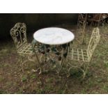 A THREE PIECE GARDEN SUITE COMPRISING OF A CIRCULAR MARBLE TOP TABLE raised on pierce and cabriole