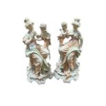 A PAIR OF WHITE PAINTED PORCELAIN GROUPS depicting classical females with cupids