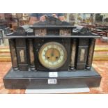 A BLACK MARBLE MANTEL CLOCK the arched top above a white enamelled dial with brass bezel and
