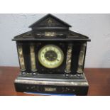 A BLACK SLATE AND MARBLE MANTEL CLOCK of architectural outline,