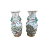 A PAIR OF GLAZED PORCELAIN ORIENTAL STYLE URNS painted with lake landscape scenes