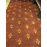 A RECTANGULAR WOOL RUG the red ground decorated overall with gold foliate motifs 201cm x 293cm