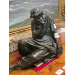 A CAST BRONZE FIGURE OF A SCHOLAR shown seated with pen and scroll 38cm x 31cm