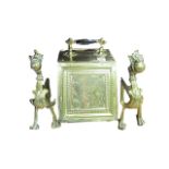 A BRASS LIFT TOP COAL SCUTTLE together with a pair of griffin dogs