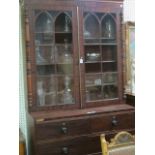 19TH CENTURY MAHOGANY BOOKCASE the arched glazed doors between engaged column sides with brass trim