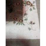 A GOOD WOOL RUG the off white and light brown field with central floral panel 295cm x 213cm