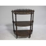 A VICTORIAN WALNUT THREE TIER WHAT NOT joined by barley twist and supports 95cm x 72cm x 34cm