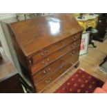 A GOOD GEORGIAN MAHOGANY BUREAU the rectangular hinged lid opening to reveal interior pigeon holes