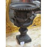 A PAIR OF CAST IRON URNS each of semi lobed form with applied decoration,