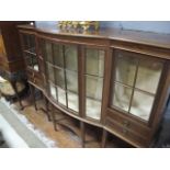 A GOOD EDWARDIAN MAHOGANY DISPLAY CABINET of rectangular bowed outline with astragal glazed doors