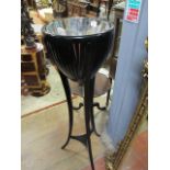 AN EBONISED JARDINIERE STAND with tin liner and three out swept legs