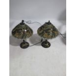 A PAIR OF TIFFANY STYLE TABLE LAMPS the stained glass shades decorated with Dragon Fly on spiral