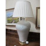A WHITE GLAZED PORCELAIN TABLE LAMP of large proportions of circular tapering form on gilded plinth