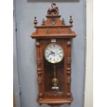 A MAHOGANY FRAMED WALL CLOCK the raised superstructure headed by a horse with turned finials,