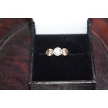 Three stone diamond ring set in 18ct gold, size N