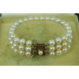 Mikimoto three-string cultured pearl bracelet with 10K gold clasp and safety chain. In original box