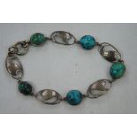 Art Nouveau silver and turquoise bracelet with hand beaten decoration