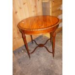 Edwardian mahogany circular occasional table with turned tapering legs and curved stretchers