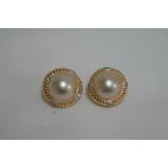 Pair of 18ct gold diamond and mother of pearl earclips marked .750