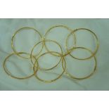 Seven Chinese gold (22ct?) bangles. 56g