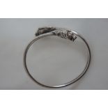 Mid 20th C silver bangle with lion's heads to each end. Marked .925