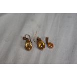 A pair of peardrop cut citrine earrings plus a pendant, all set in gold metal