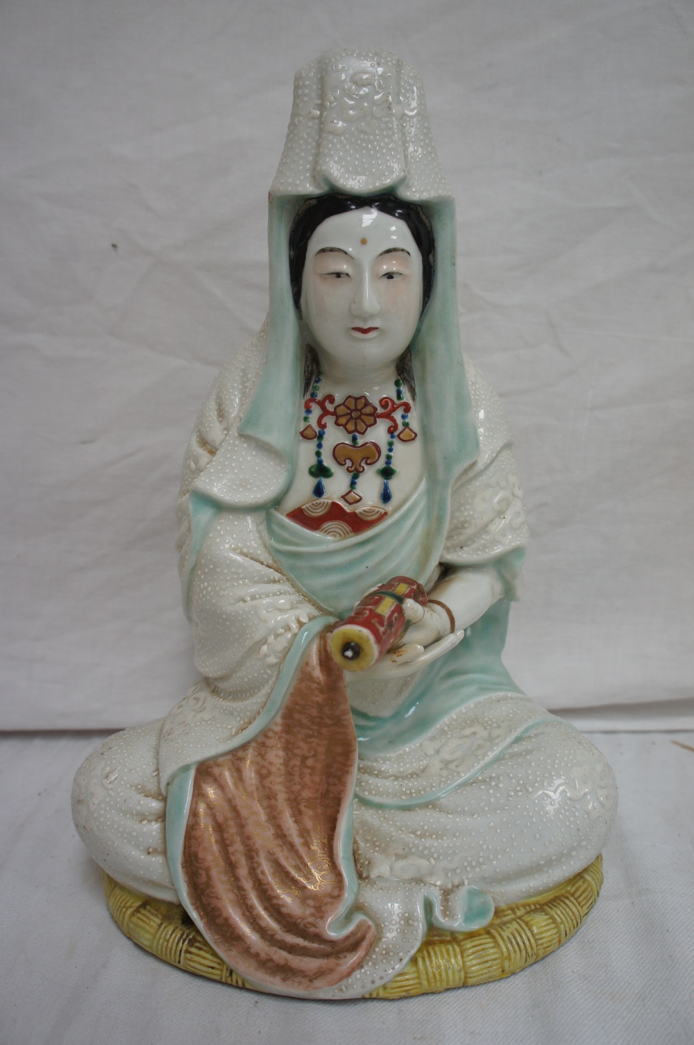 Late 19thC Oriental figure holding a scroll. Ht 10.5 ins.