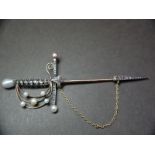 Fine 19thC gold pin in the form of a Spanish style sword having pearl to top handle and guard with