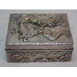 19th / 20thC Chinese chased silver box with decoration of dragons fighting to top and wave