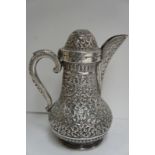 Late 19thC Indian chased silver coffee pot with decoration of flora and fauna, marked T95 and RM