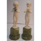 Ferdinand Preiss 1) Girl holding a box 2) Boy holding an apple - Ivory on green onyx octagonal