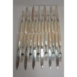 Set of twelve pairs of silver-bladed, mother of pearl handled dessert eaters, Sheffield 1910, makers