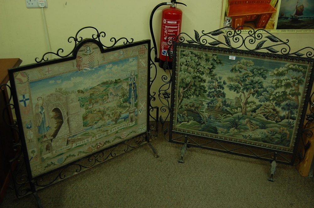 Two wrought iron frame fire guards with fine needlework inserts