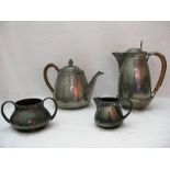 Pewter tea set by Hutton, Sheffield. Tea and coffee pots with woven rattan covered handles