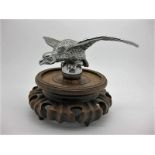 Chromed eagle car mascot on carved hardwood stand. Wingspan 7 inches