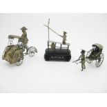 Three Oriental white metal items - fisherman on well carved hardwood stand, a man pulling a rickshaw