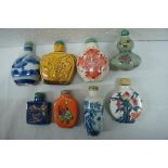 Eight Chinese porcelain snuff bottles marked to bases. Tallest 2.5 ins.