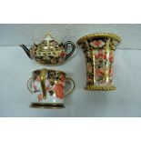 Three miniature Royal Crown Derby items - tyg, teapot and vase in the Imari pattern