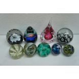 Nine glass paperweights including Caithness