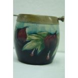 Moorcroft barrel shaped ashtray with plum design on a dark background. Ht. 3 ins., signed to base.