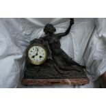 French spelter figure mantel clock with red figured marble base, "Bachante" and chiming on a bell,