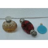 Victorian ruby glass double ended silver top scent bottle together with two others